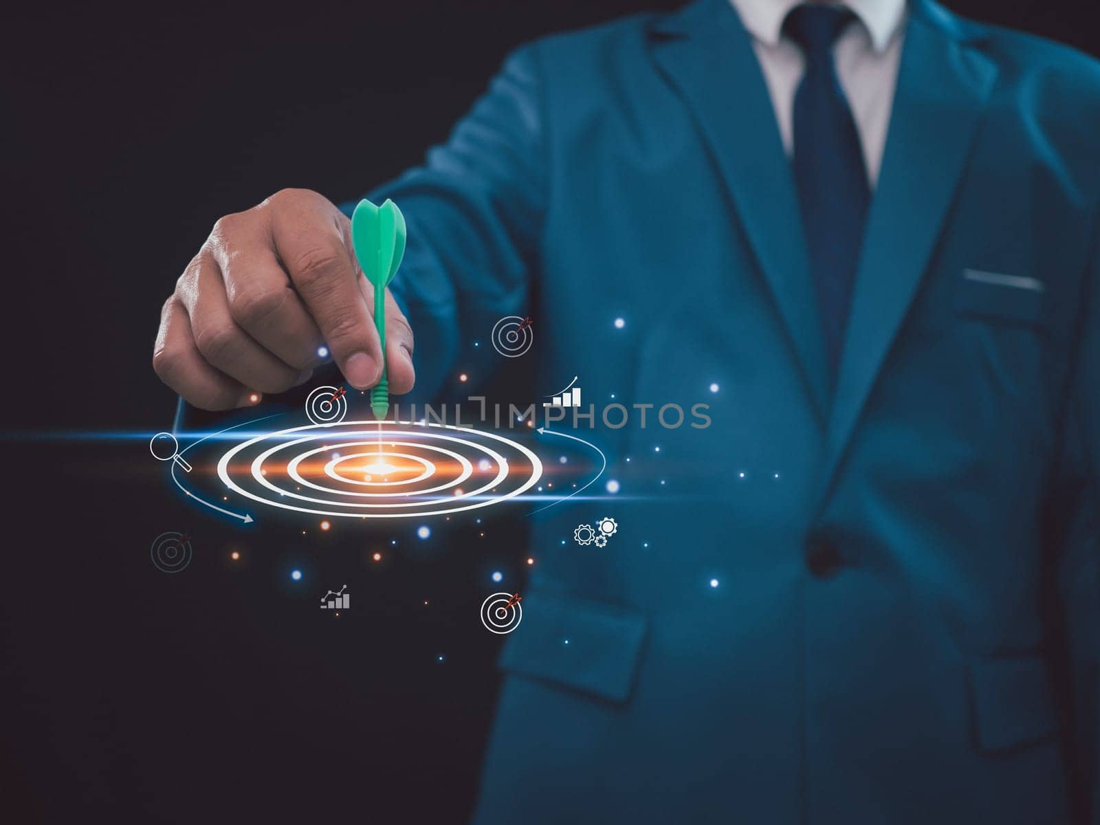 Businessman holding a green arrow pointing to the center of the target. Business concept. Management concept, business planning concept. business goal setting concept