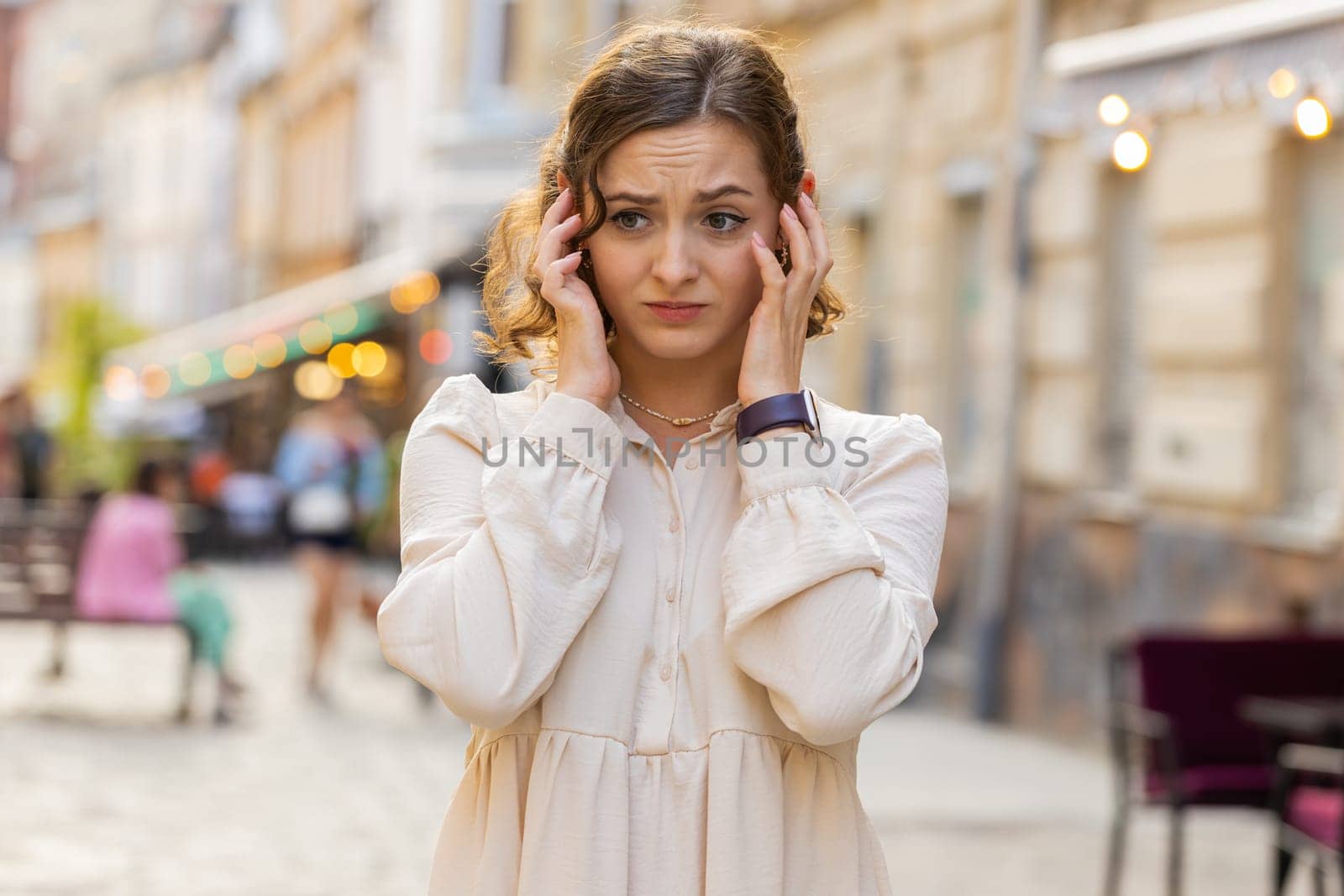 Sad unhappy pretty young woman thinks over life concerns, suffers from unfair situation. Problem, feeling bad, annoyed, burnout, grief. Frustrated depressed lonely girl tourist walking in city street