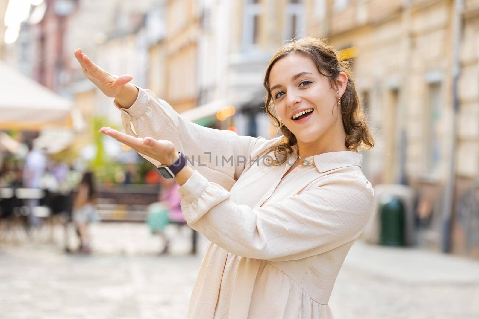 Cheerful rich young pretty woman showing wasting throwing money around hand gesture, more tips earnings, big profit, win lottery, share, celebrate. Lovely girl walking in urban city street outdoors