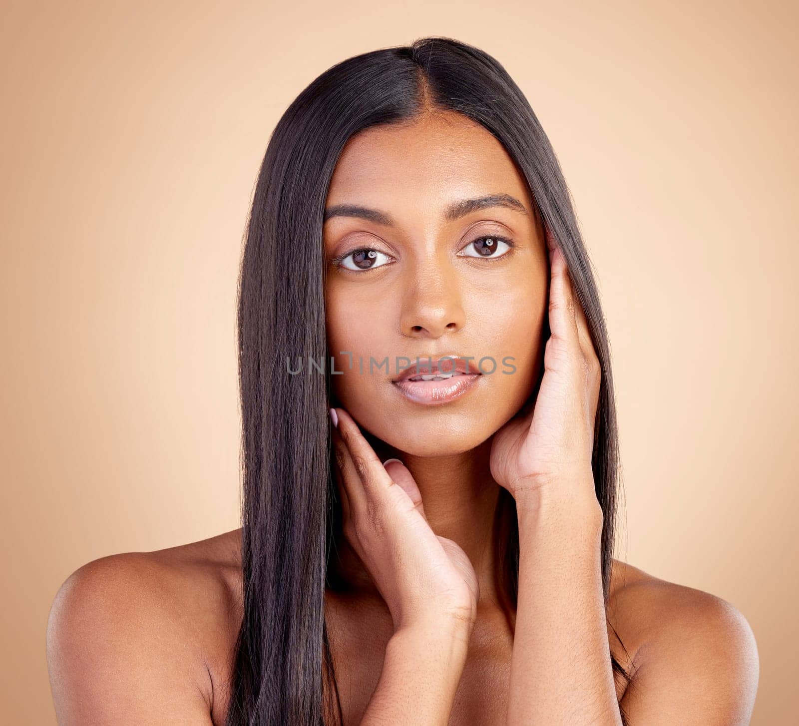 Portrait, hair care and Indian woman with cosmetics, makeup and skincare on a brown studio background. Face, female person and model with volume, texture and scalp treatment with natural beauty.