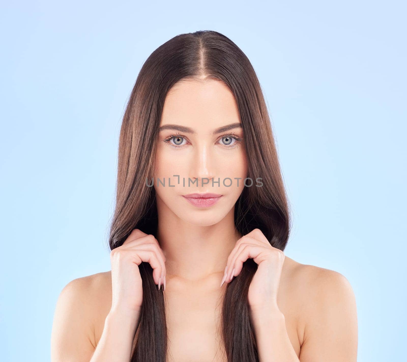 Portrait, texture and woman with hair care, cosmetics and wellness on a blue studio background. Female person, aesthetic or model with volume, natural beauty and luxury with self care and dermatology.