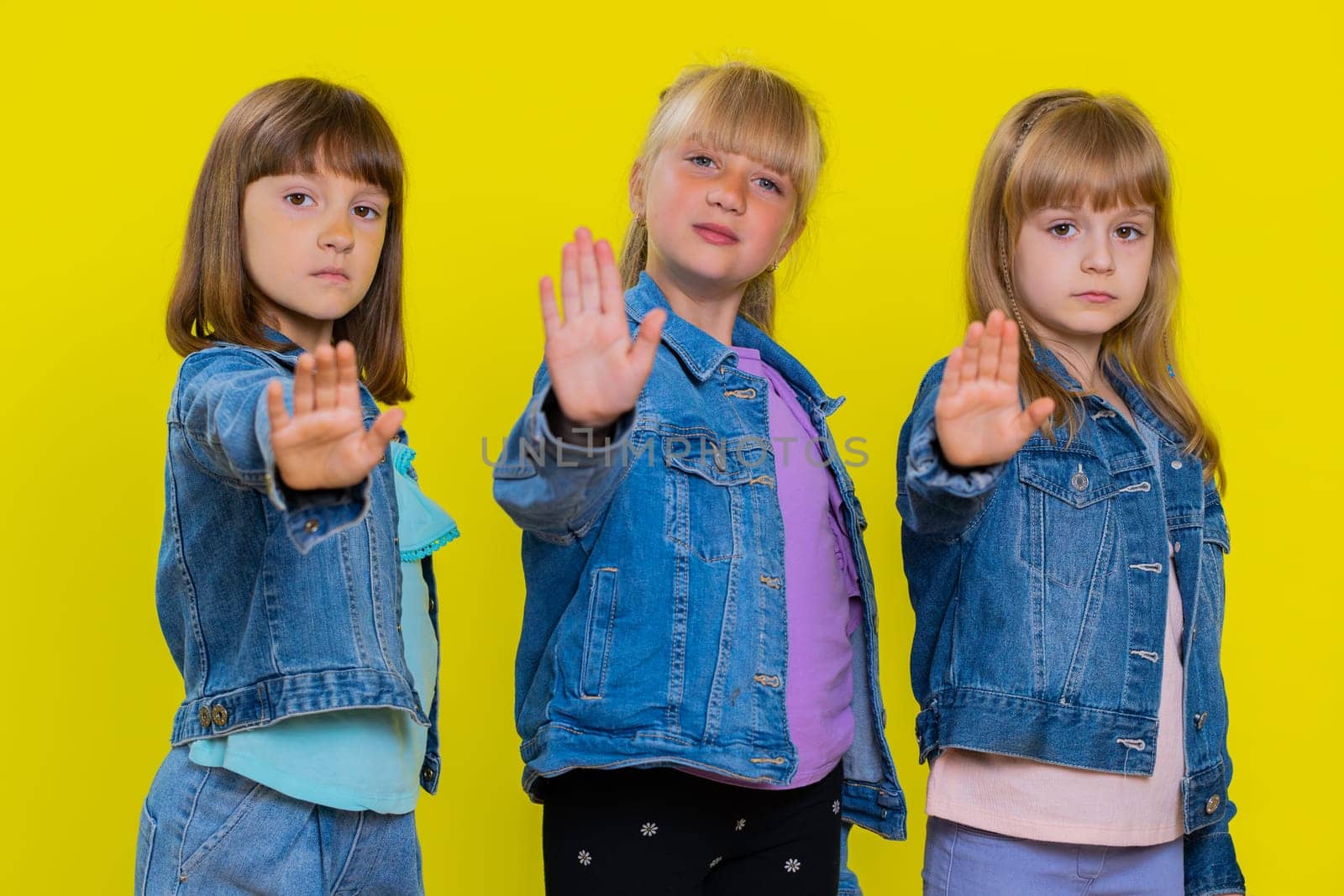 Three girls siblings friends say No, showing stop gesture, prohibited access declining communication by efuror