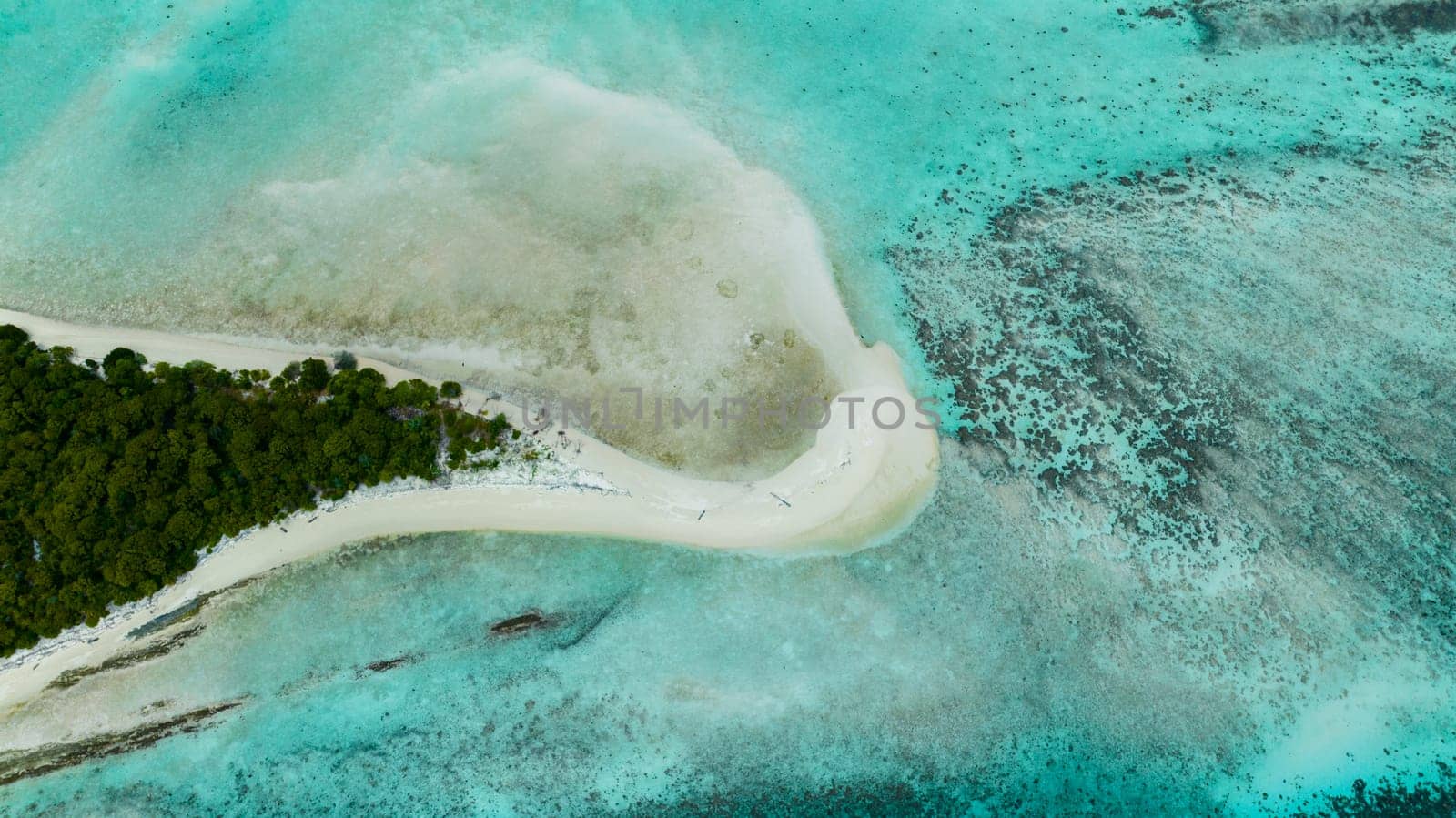 Aerial view of tropical island Mataking with coral reef and atoll view from above. Tun Sakaran Marine Park. Borneo, Sabah, Malaysia.