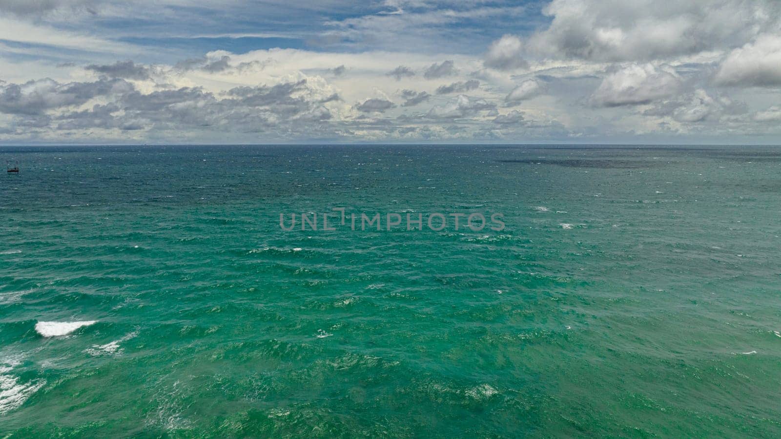 Blue ocean with waves and blue skies with clouds. Seascape in the tropics. Borneo, Malaysia.