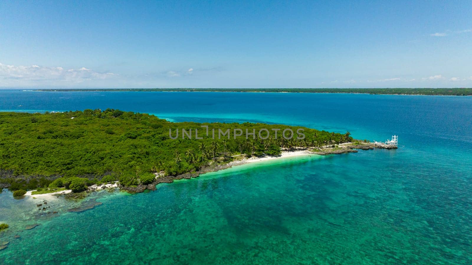 Island with a beach in the tropics. Virgin Island, Philippines.