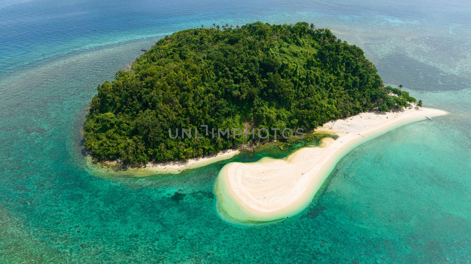 Top view of island in the blue sea with atoll and the beach. Agutaya island, Philippines.