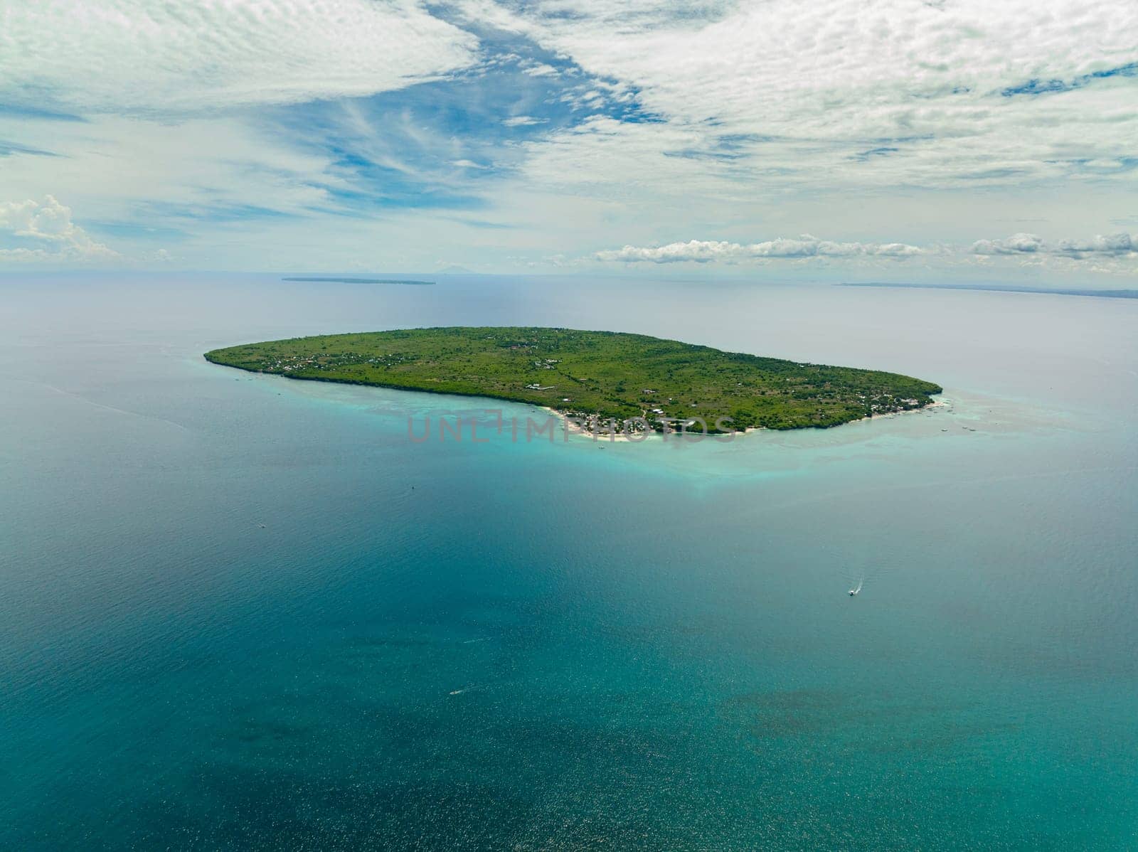 Tropical island with a beach in the open ocean. Virgin Island, Philippines.