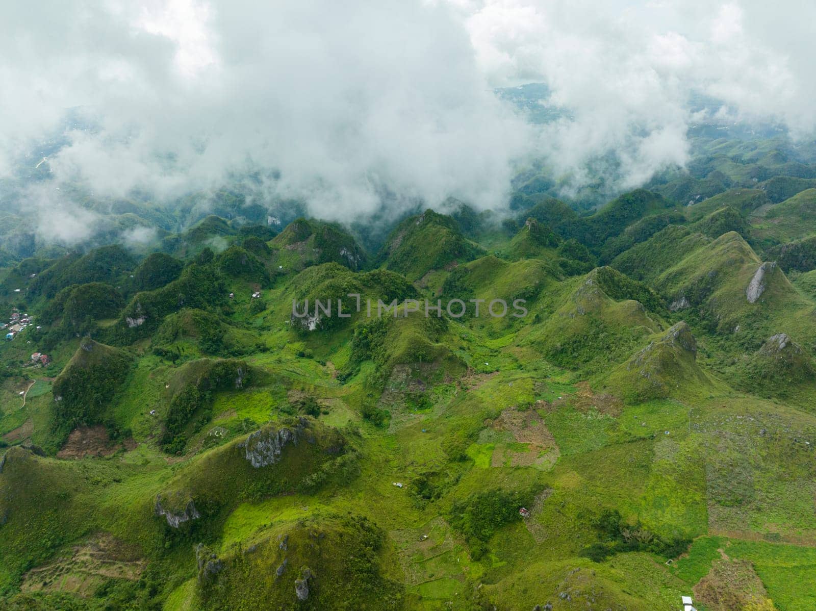 Top view of green mountains and hills covered with clouds. Osmena Peak. Mountain landscape. Cebu Philippines.