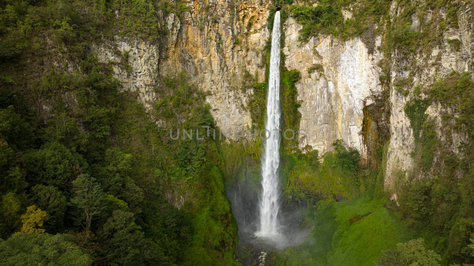 Waterfall in a tropical forest. Sipiso Piso falls. Sumatra, Indonesia.