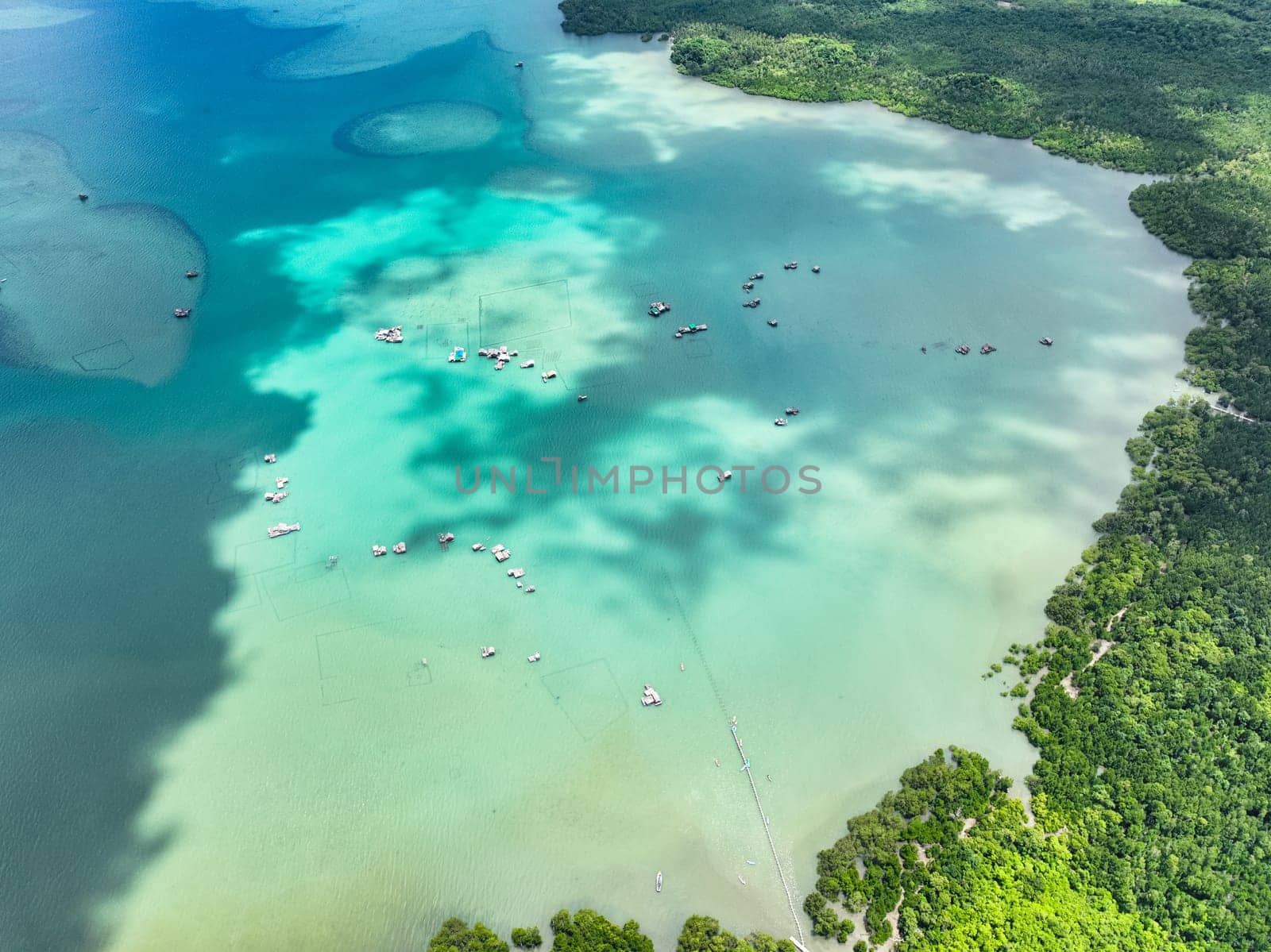 Bay with turquoise water and boats. Balabac, Palawan. Philippines.