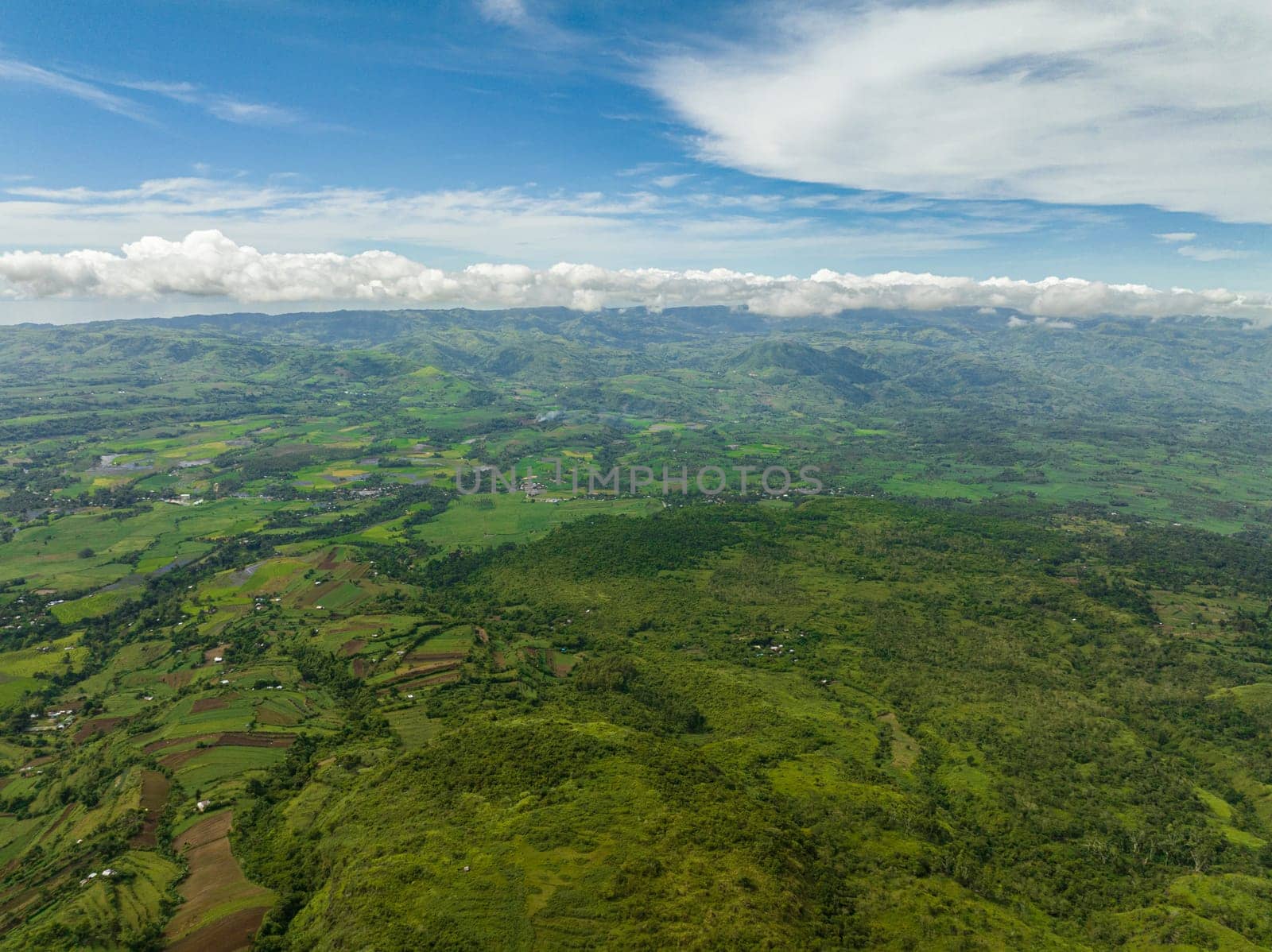 Aerial view of valley with farmland and agricultural land in mountainous area. Negros, Philippines