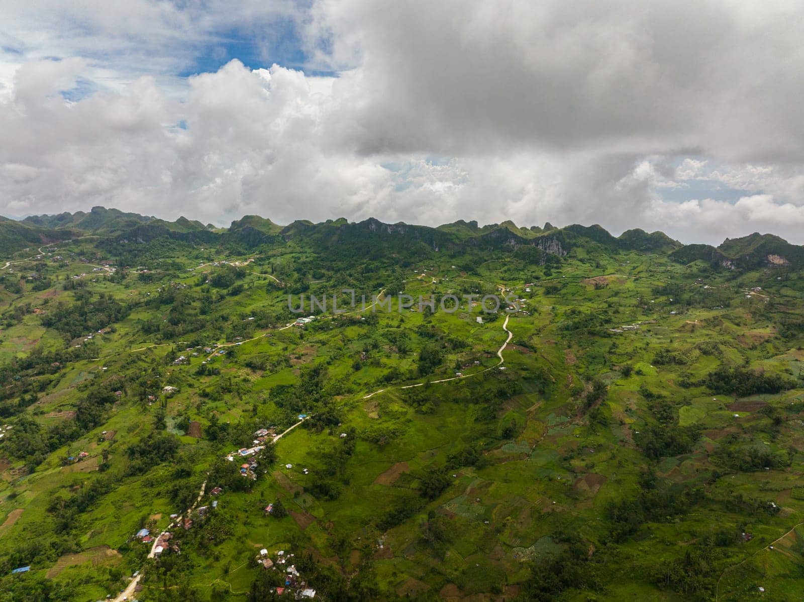 Aerial view of agricultural land among mountains and hills in the countryside. Cebu island, Philippines.