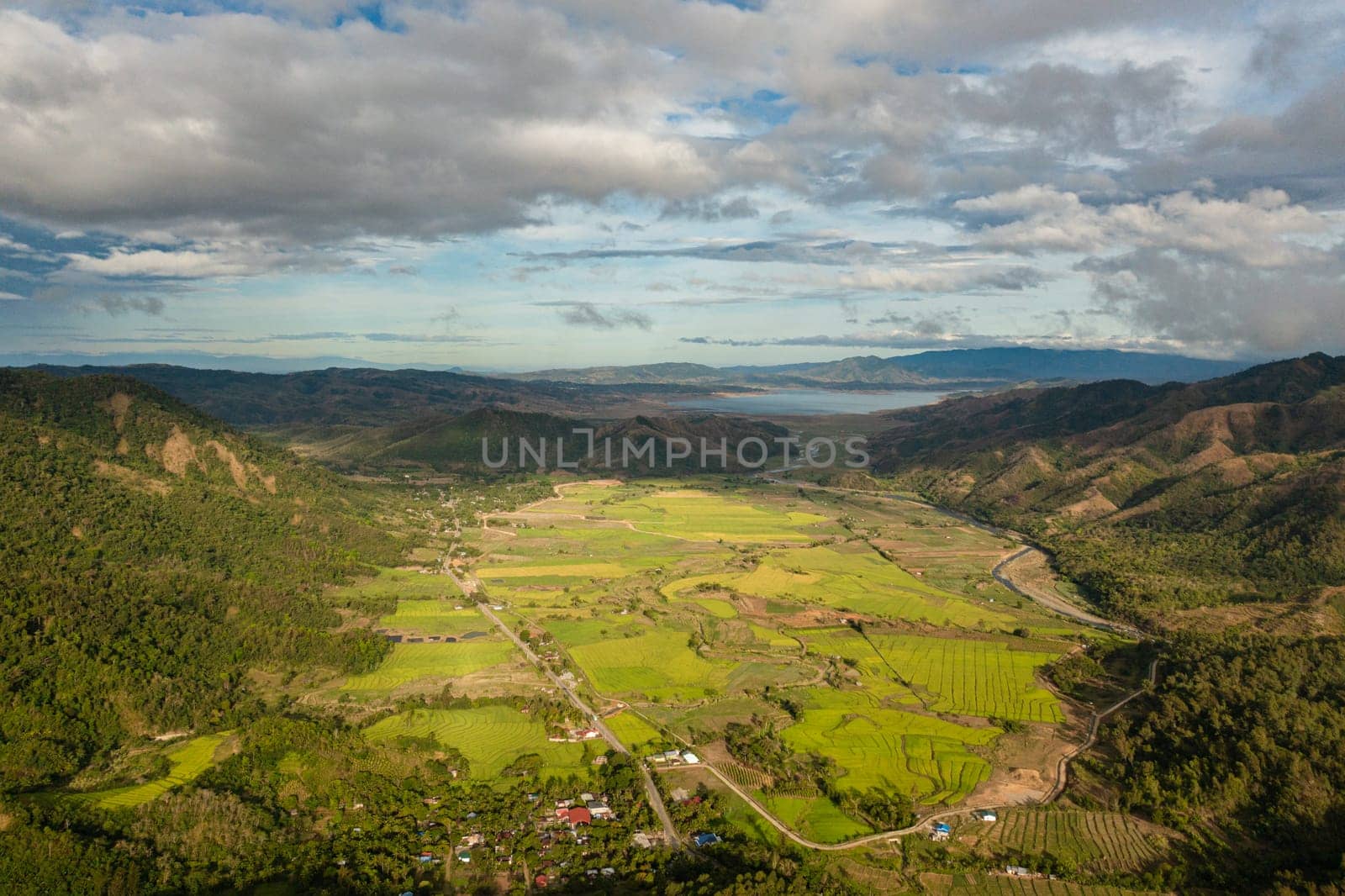 Mountain slopes with rainforest and a mountain valley with farmland. Philippines.