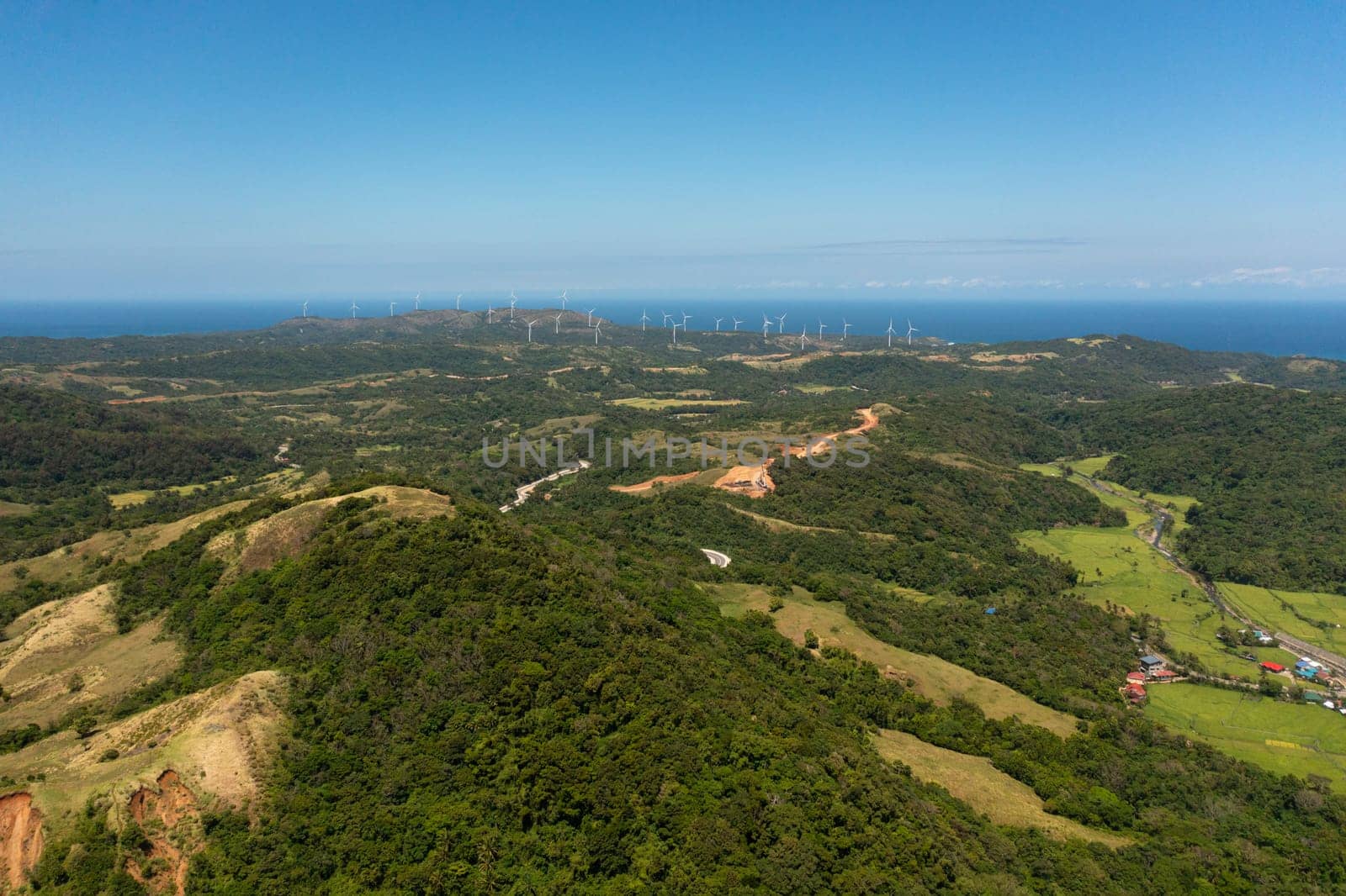Wind turbines producing clean sustainable energy, clean energy future. Wind power plant. Philippines.