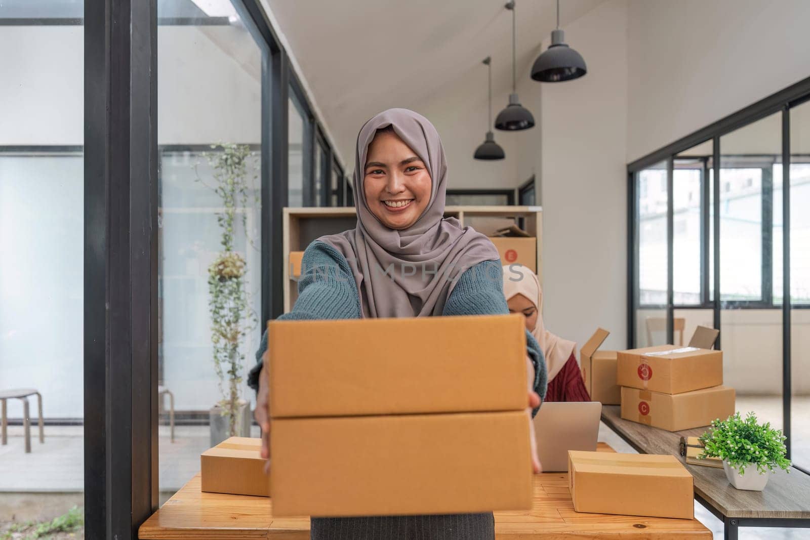 Beauty muslim woman in hijab working sell products online in the office.
