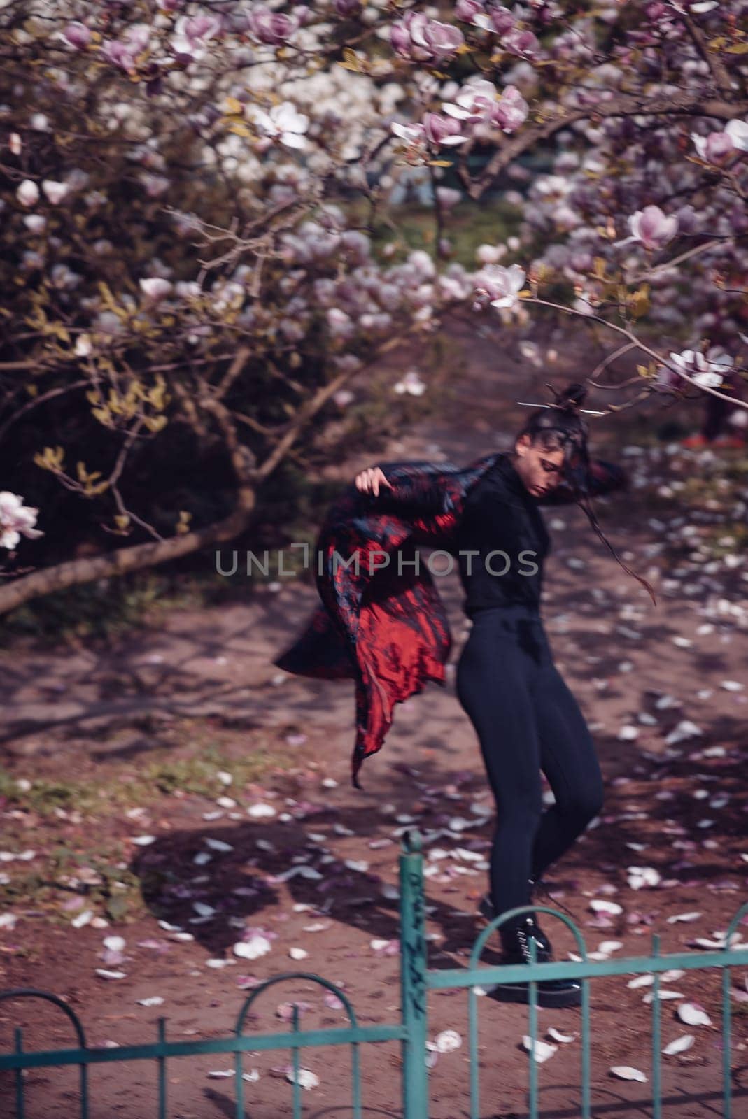 Beautiful dramatic young woman wearing kimono with cherry blossoms, sakura view. High quality photo