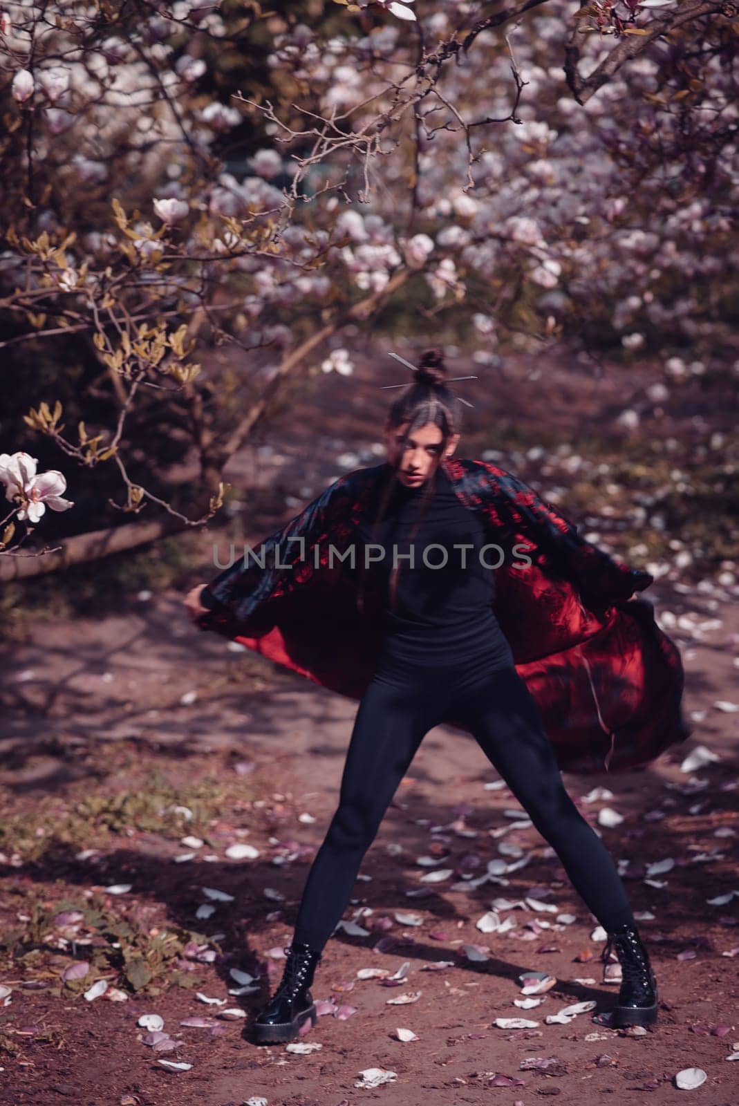 Beautiful dramatic young woman wearing kimono with cherry blossoms, sakura view. High quality photo