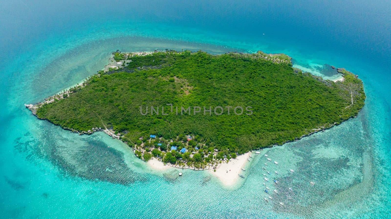 Top view of tropical island with a beach in the open ocean. Virgin Island, Philippines.