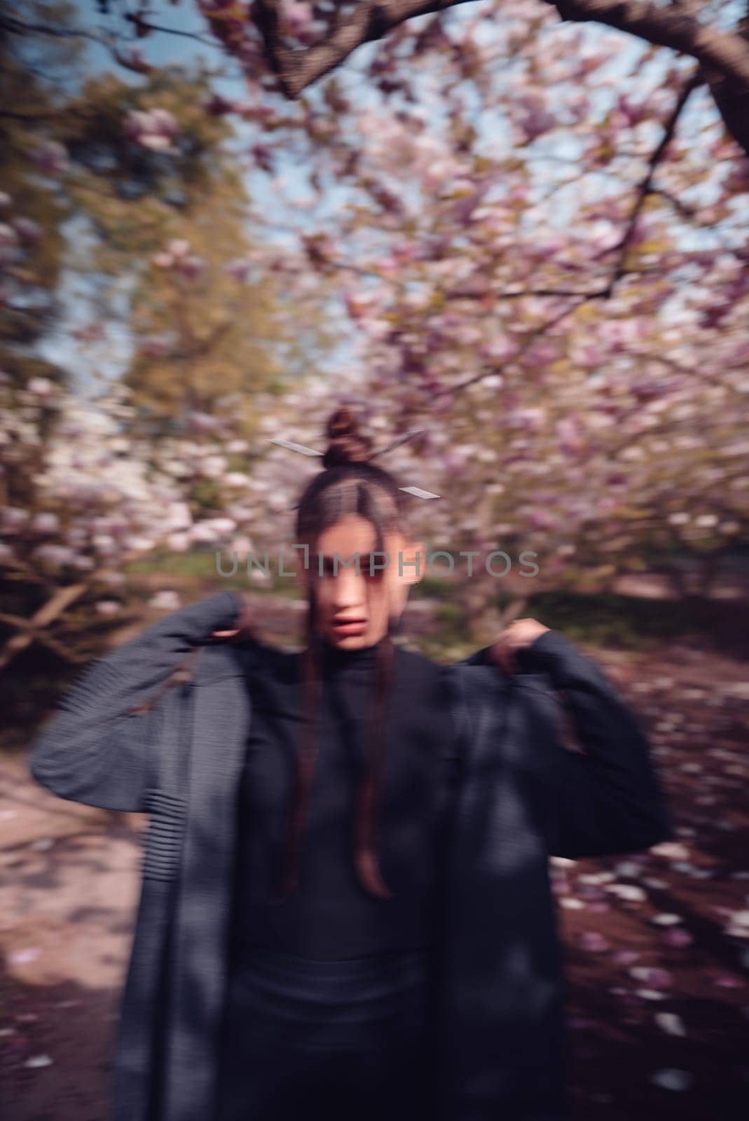 Beautiful dramatic young woman wearing kimono with cherry blossoms, sakura view. High quality photo