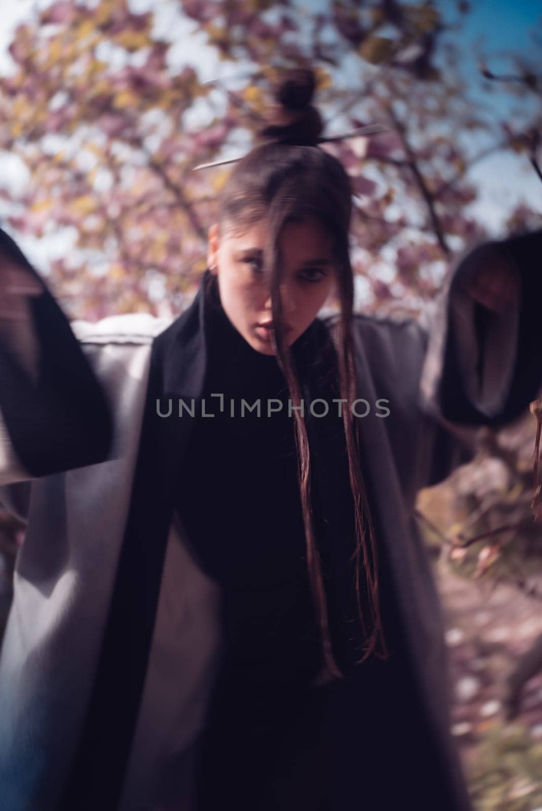 Beautiful dramatic young woman wearing kimono with cherry blossoms, sakura view. High quality photo