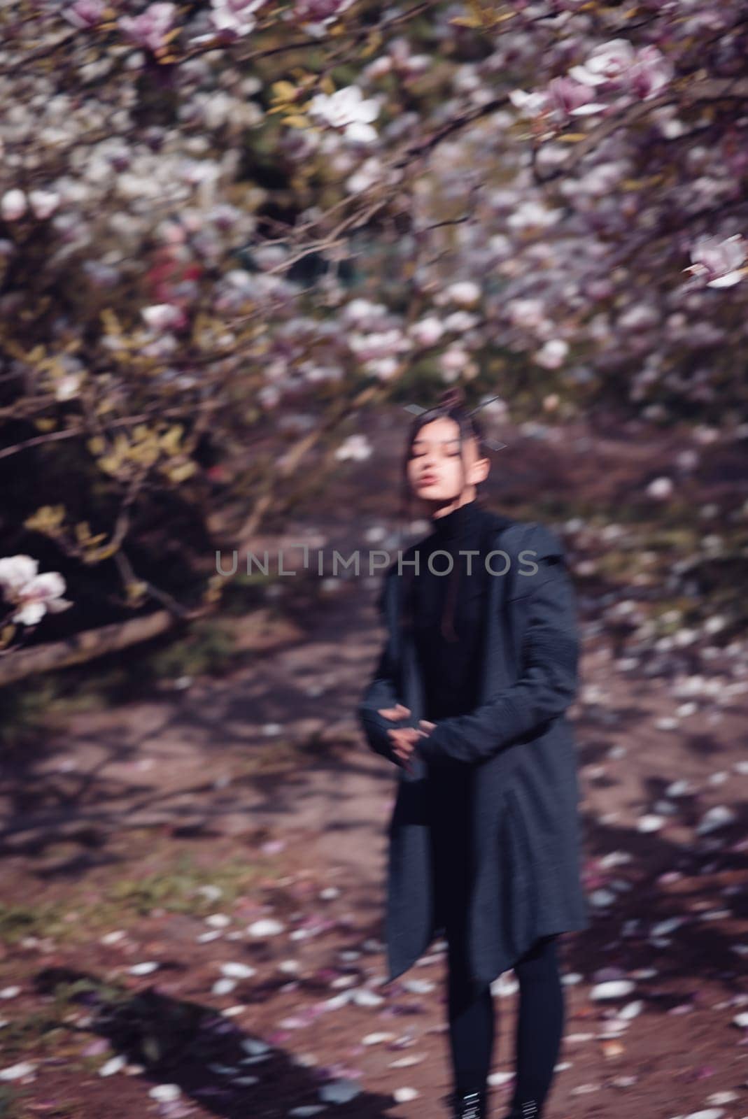 Beautiful dramatic young woman wearing kimono with cherry blossoms, sakura view. High quality photo