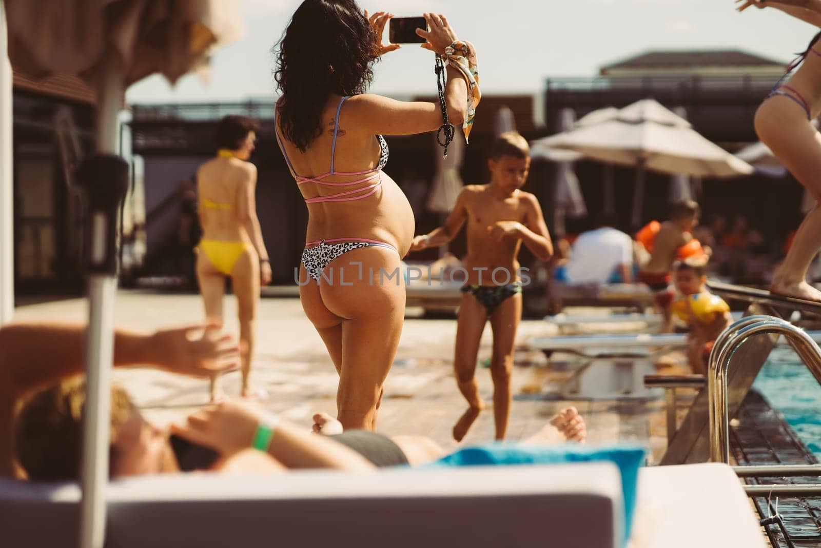 back view of pregnant woman in bikini on the beach. High quality photo