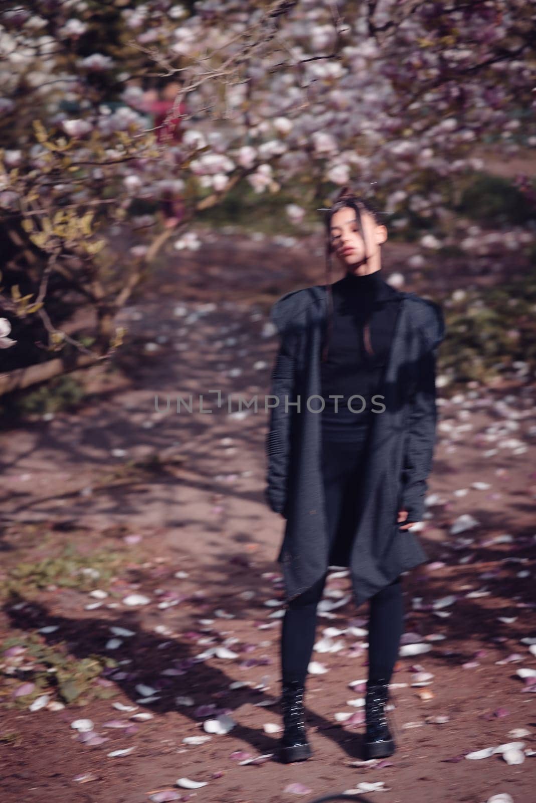 Beautiful dramatic young woman wearing kimono with cherry blossoms, sakura view. High quality photo