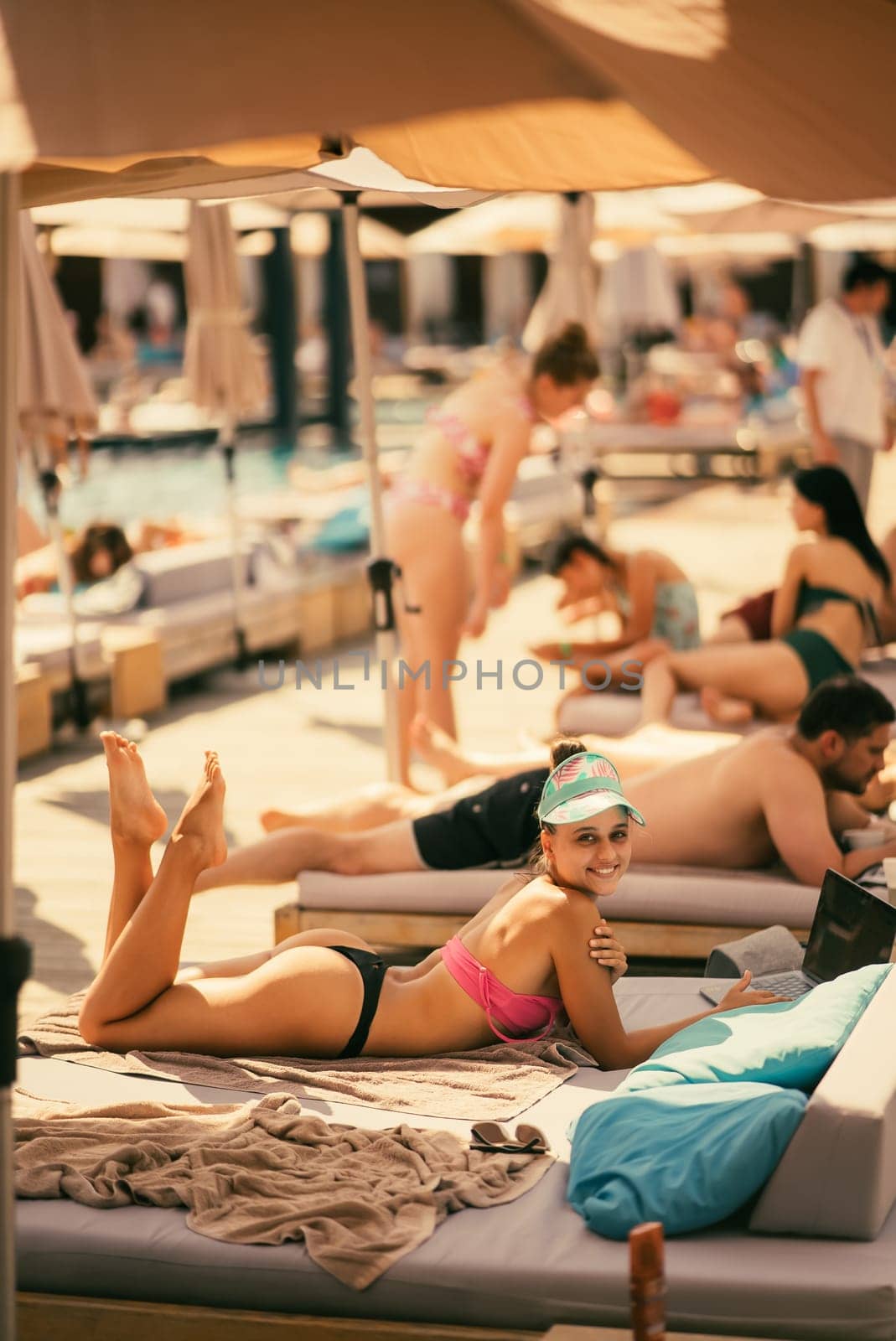 beautiful girl in bikini laying and sunbathing on the beach. High quality photo