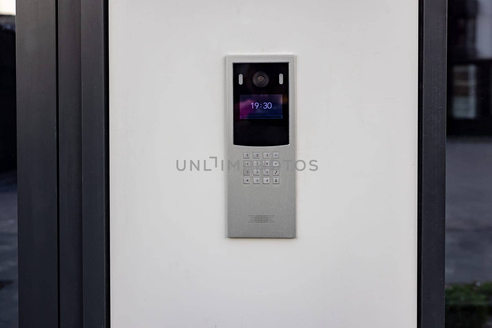 Doorbell with video camera and microphone, on the white wall of an apartment building, doorbell camera by voronaman