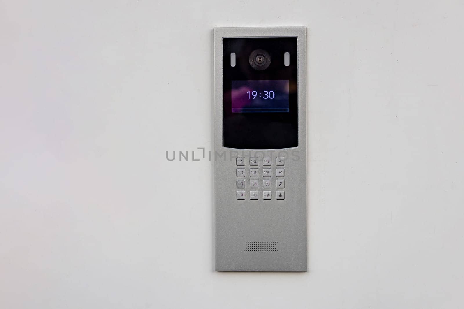 Doorbell with video camera and microphone, on the white wall of an apartment building, doorbell camera by voronaman