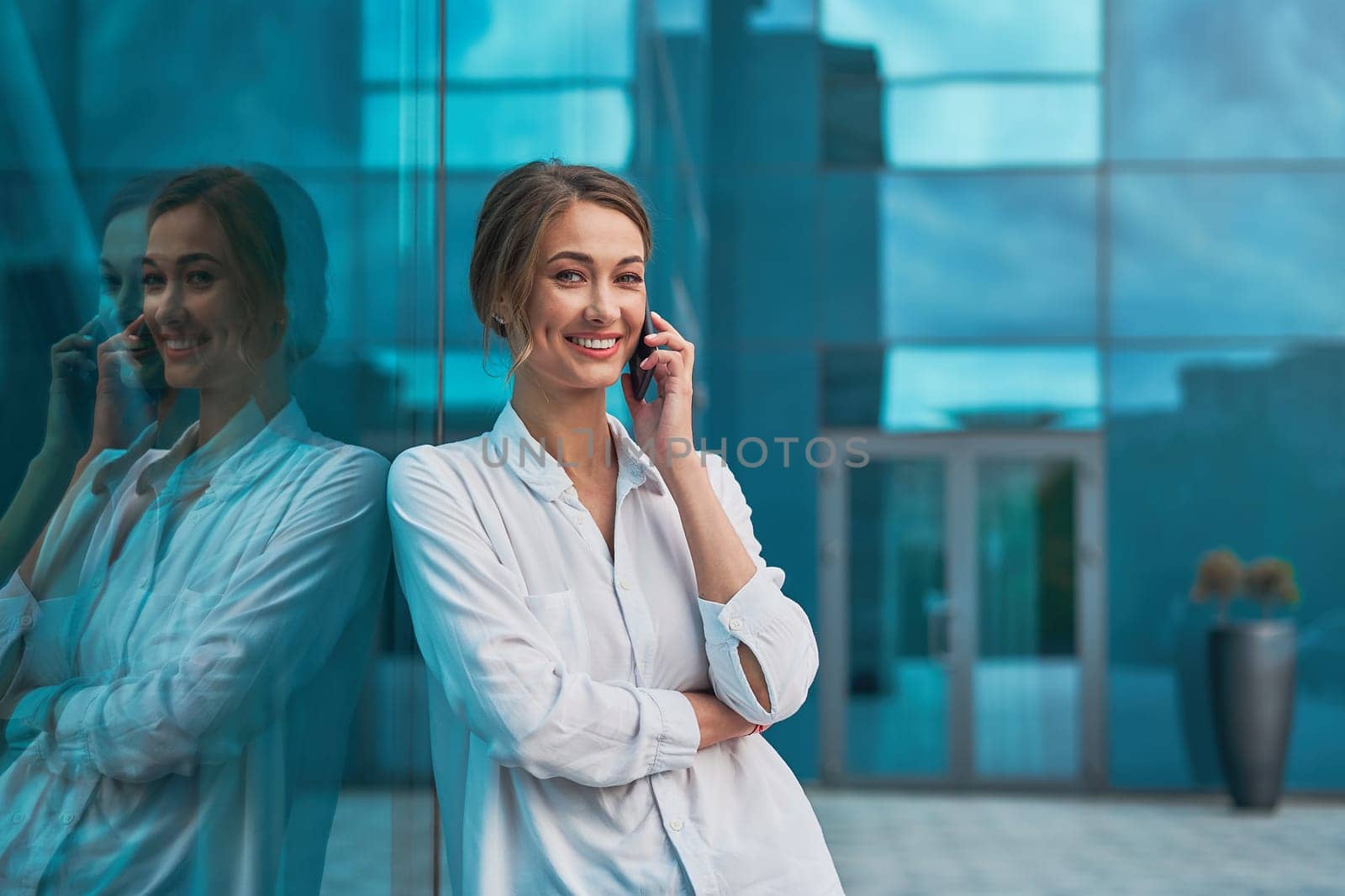 Businesswoman successful woman business person standing outdoor corporate building exterior cell phone Pensive elegance cute caucasian professional businesswoman