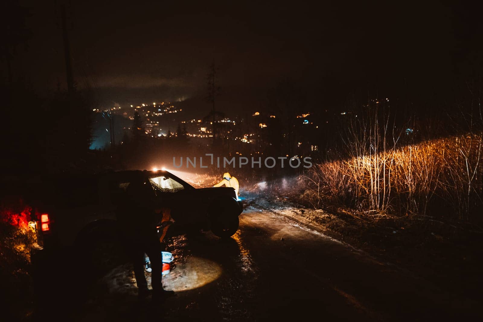 Man preparing bbq grill to cook on fire. Outside dark shot. Freeze moment of fire by teksomolika