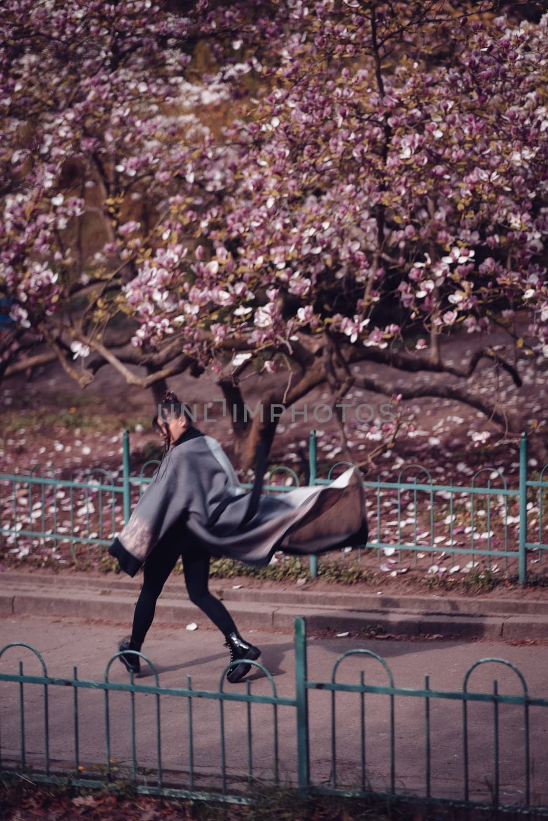 Beautiful dramatic young woman wearing kimono with cherry blossoms, sakura view. High quality photo