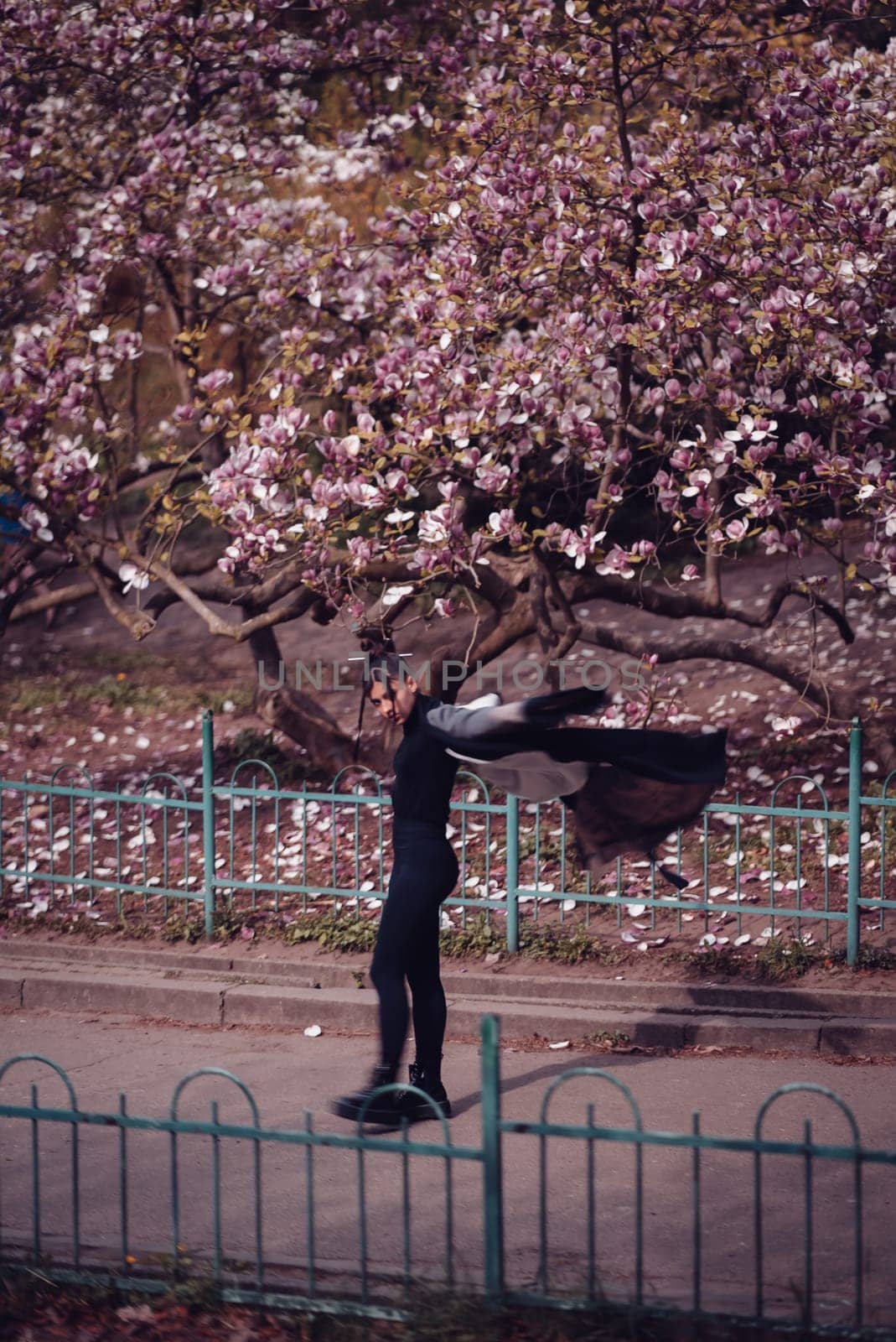 Beautiful dramatic young woman wearing kimono with cherry blossoms, sakura view. High quality photo