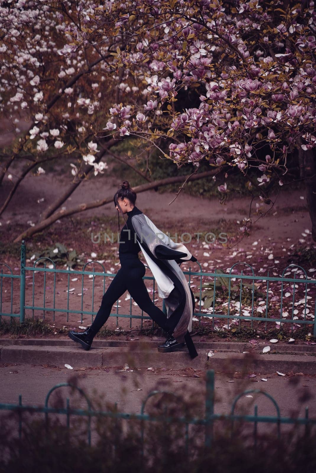 Beautiful dramatic young woman wearing kimono with cherry blossoms, sakura view. High quality photo