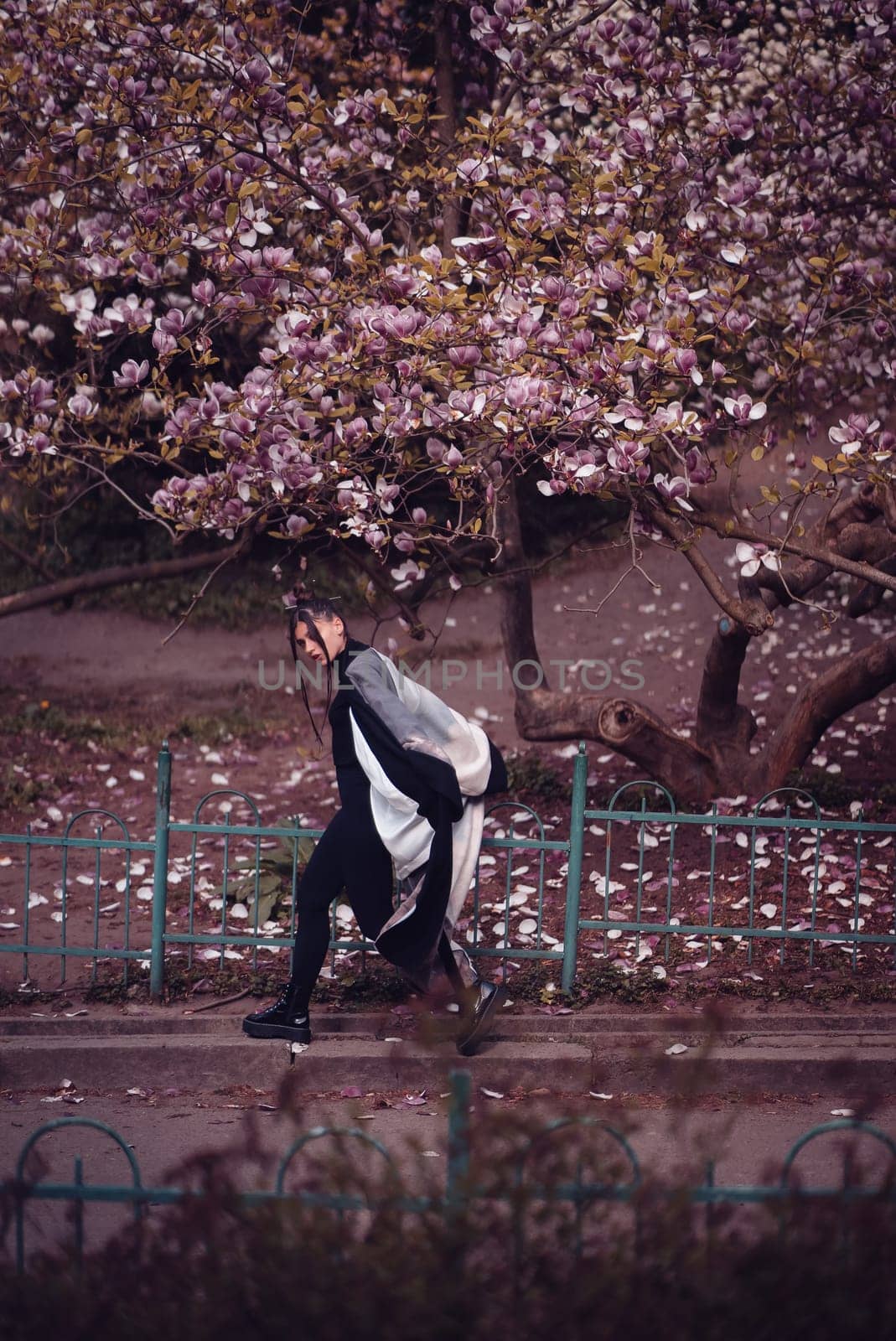 Beautiful dramatic young woman wearing kimono with cherry blossoms, sakura view. High quality photo