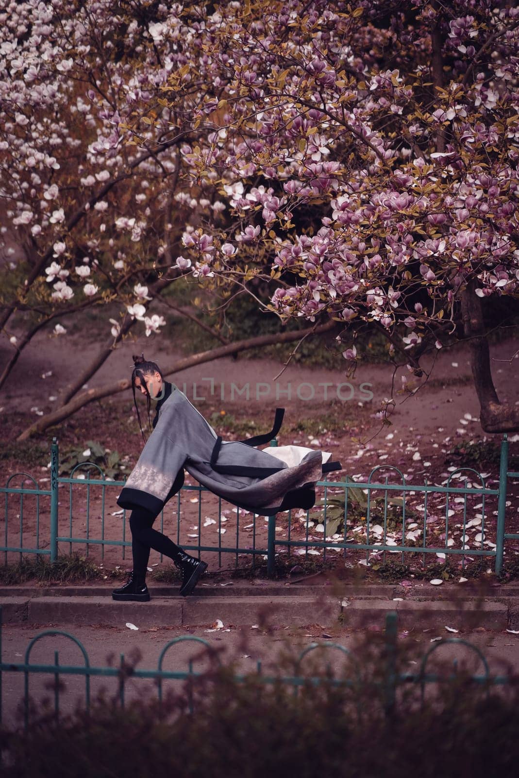 Beautiful dramatic young woman wearing kimono with cherry blossoms, sakura view. High quality photo