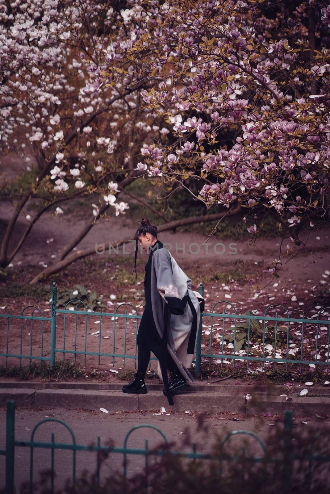 Beautiful dramatic young woman wearing kimono with cherry blossoms, sakura view. High quality photo