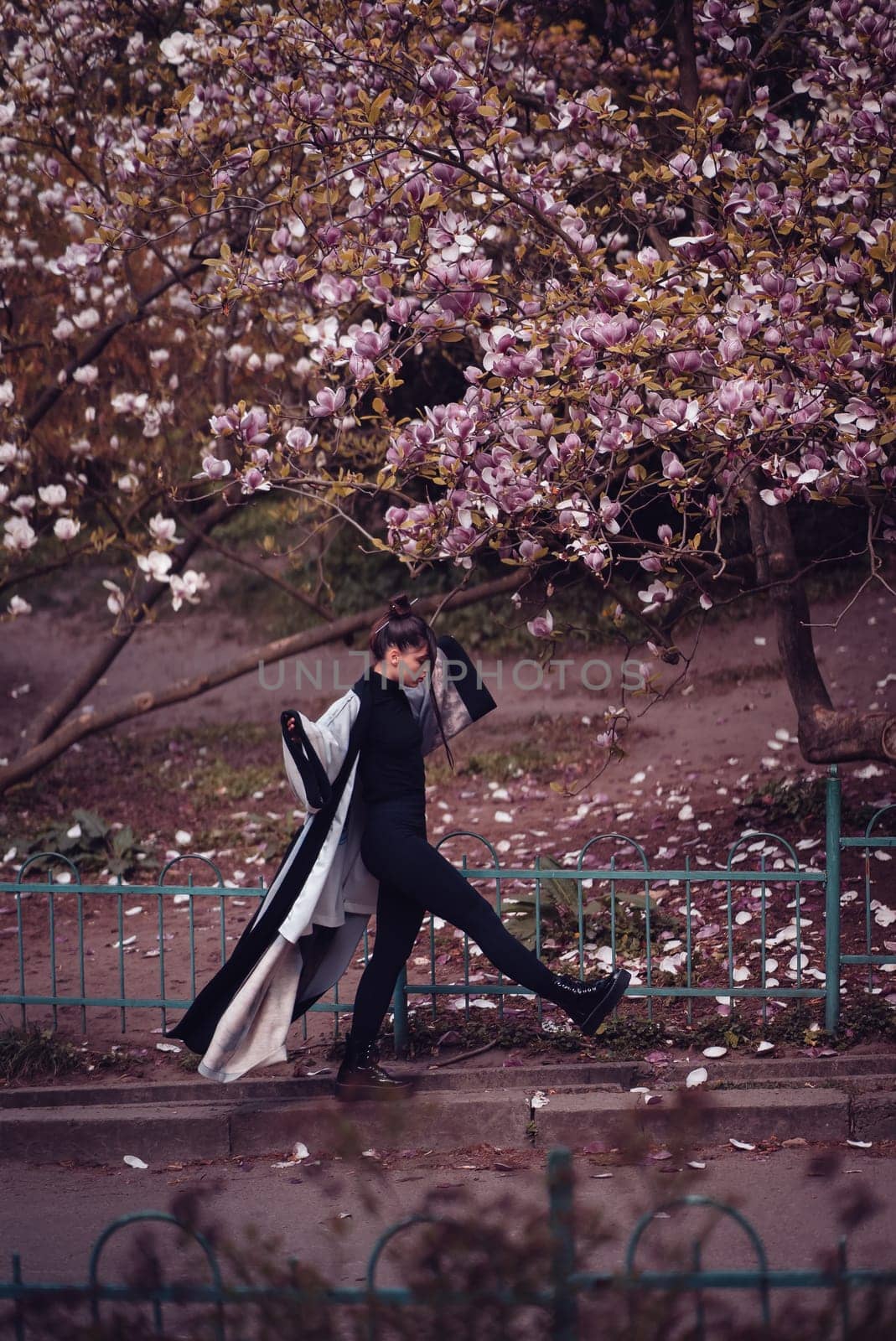 Beautiful dramatic young woman wearing kimono with cherry blossoms, sakura view. High quality photo