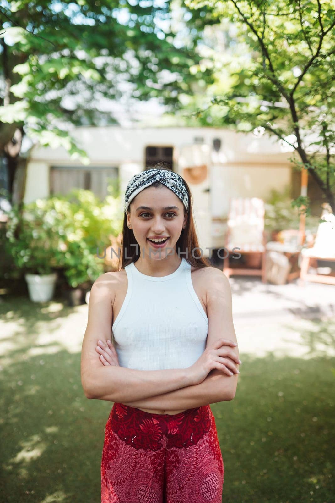 Happy hippie girl are having a good time in a camper trailer. Holiday, vacation, trip concept.High quality photo