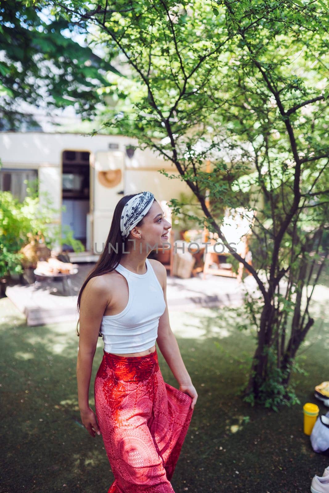 Happy hippie girl are having a good time in a camper trailer. Holiday, vacation, trip concept.High quality photo
