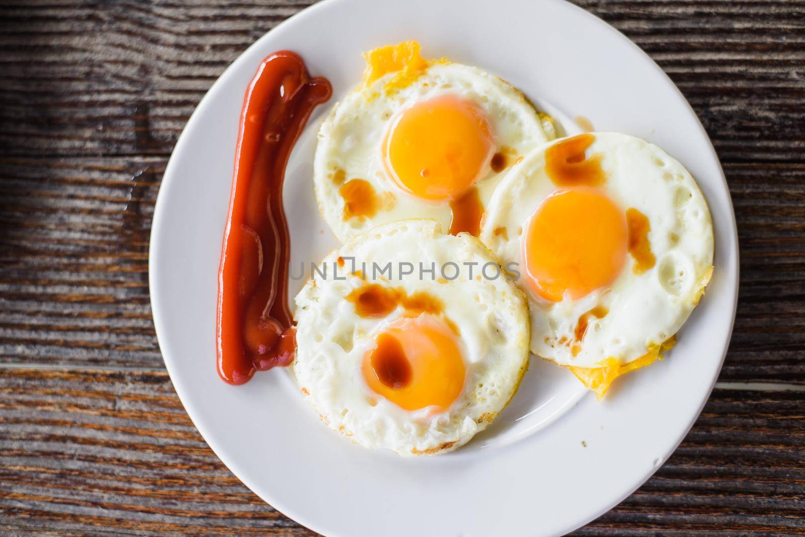 Fried Eggs on a dish on wood table