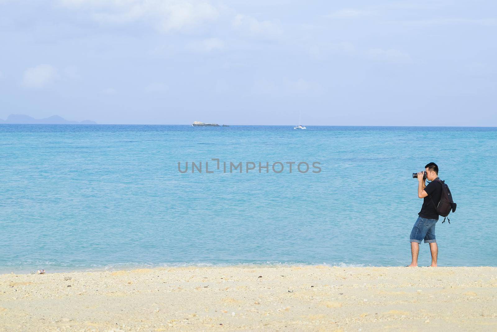 photographer take a photo at the sea by Wmpix