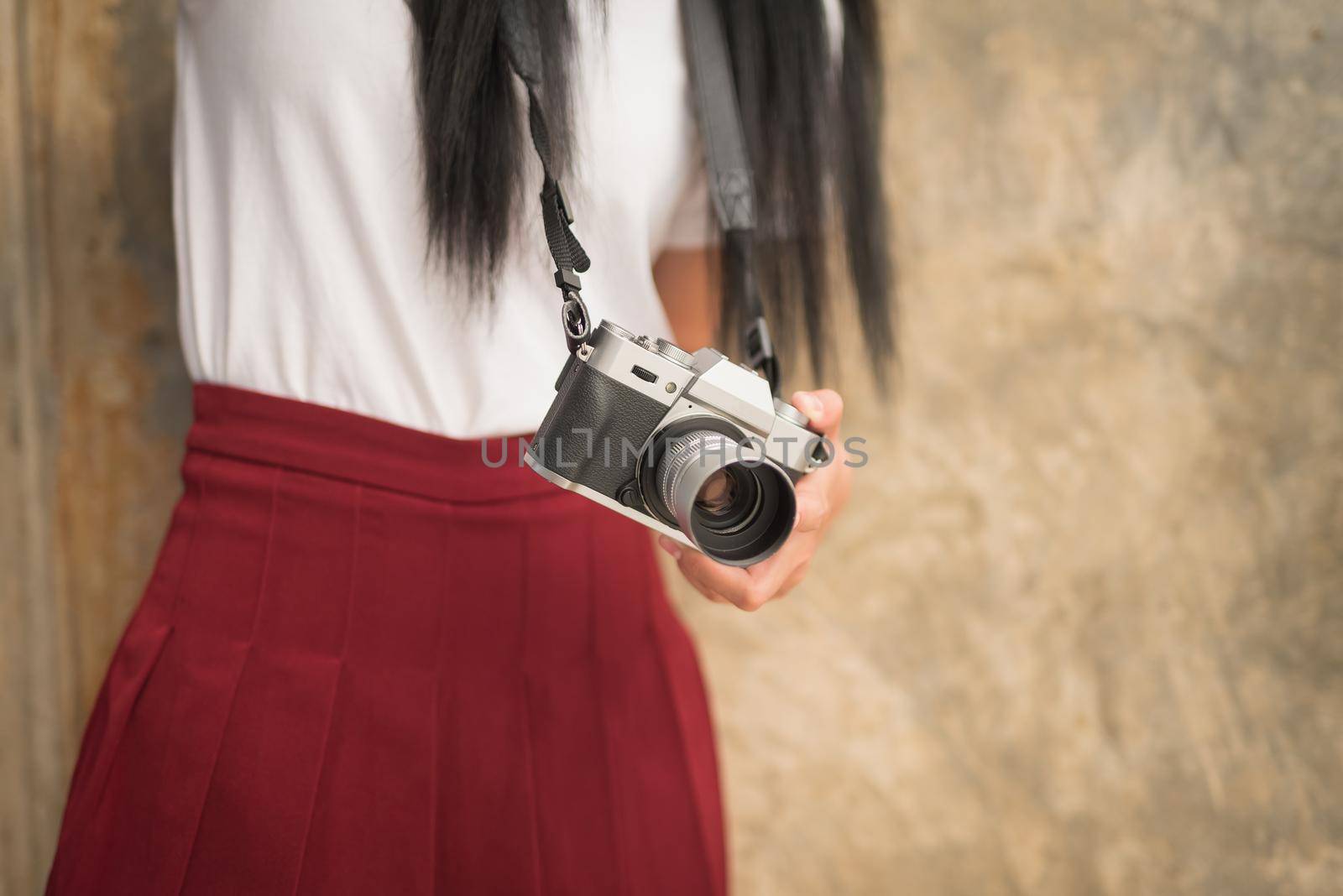 Girl with vintage camera in the hands by Wmpix