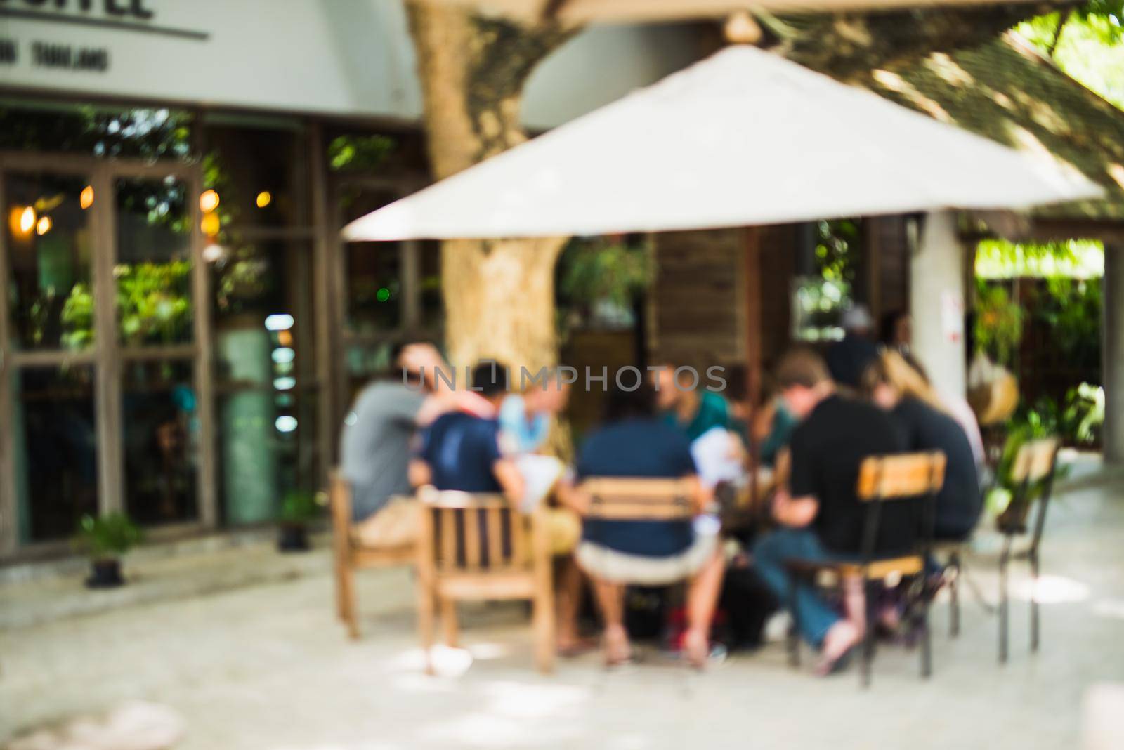 abstract blur of people sitting in the cafe bar outdoor background by Wmpix