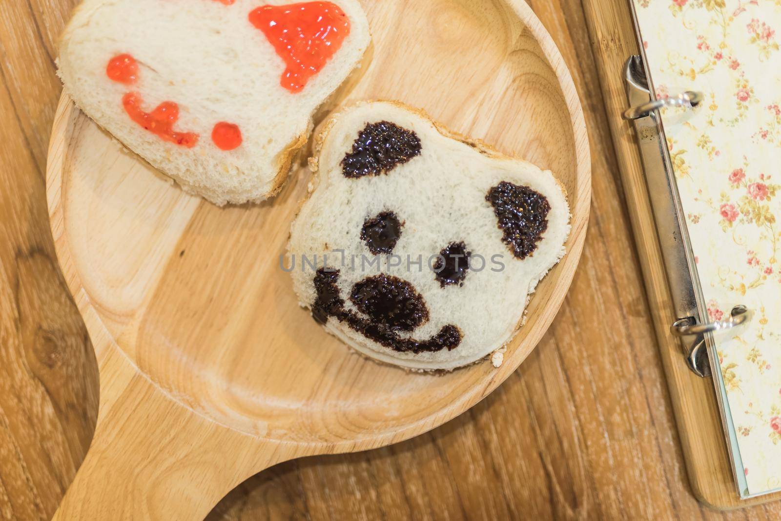 panda on toasted bread on wood table by Wmpix