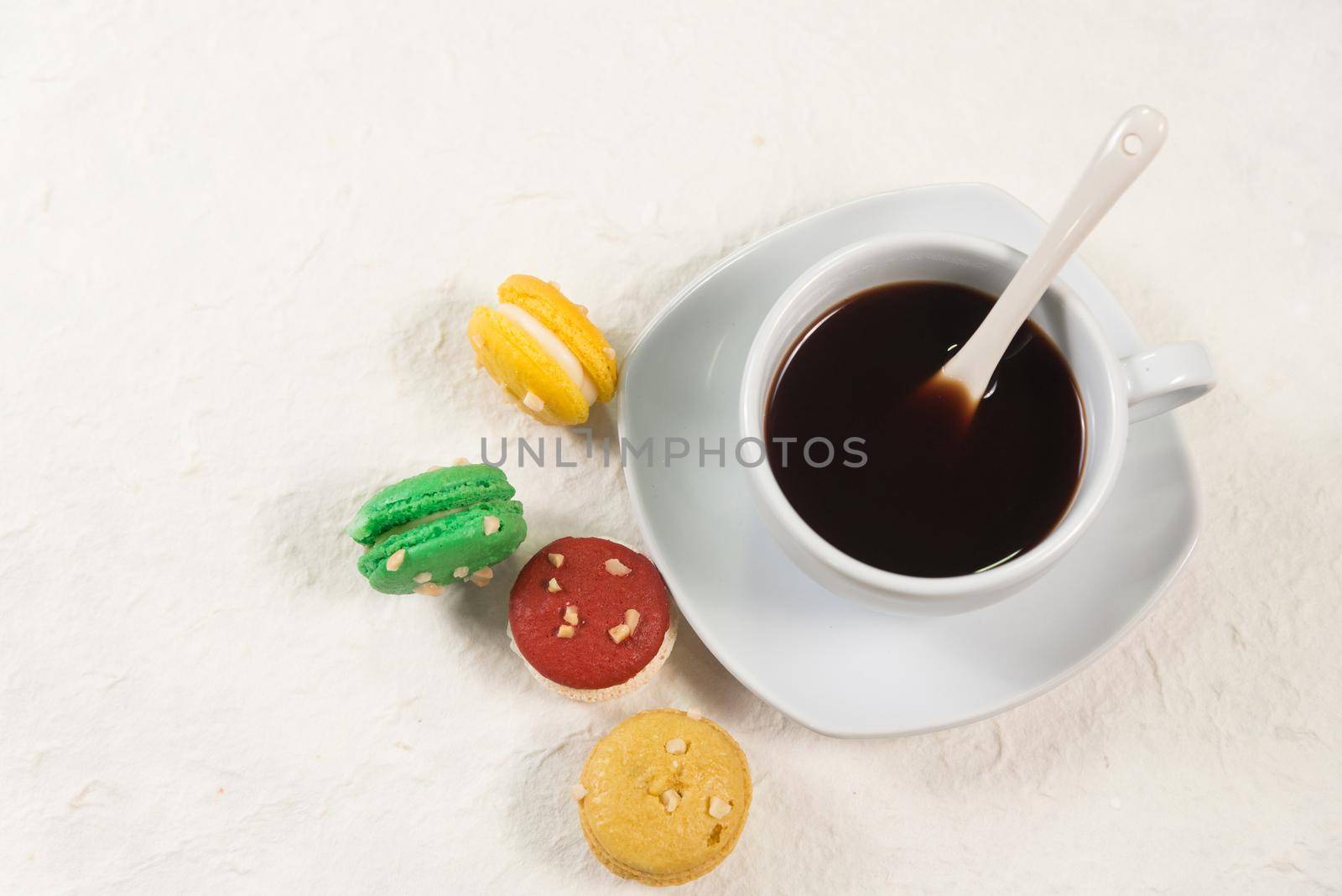 colourful french macaroons with cup of coffee by Wmpix