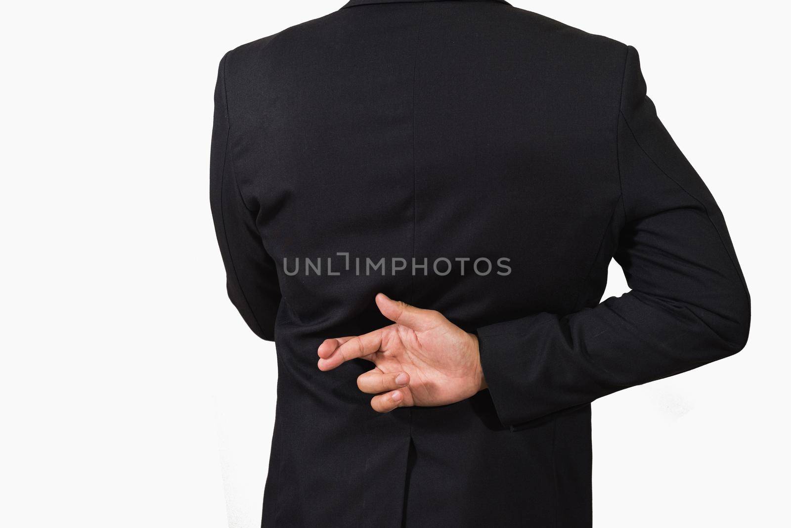 Businessman in dark suit with crossed fingers behind his back