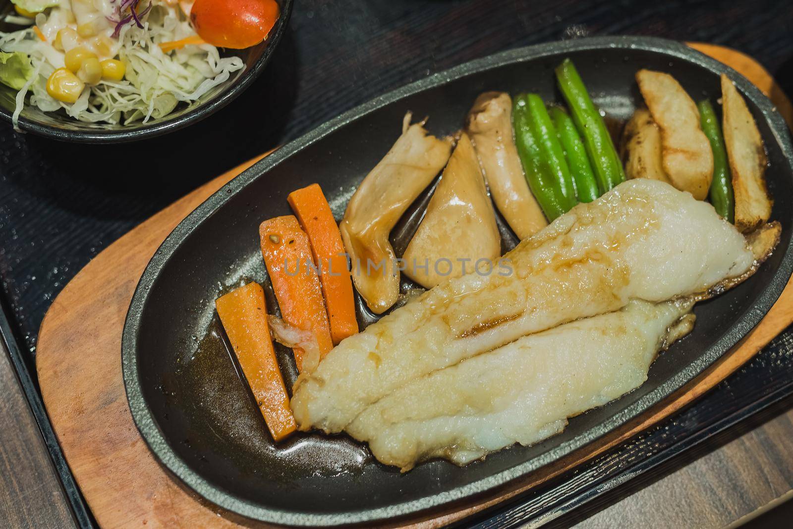 fish steak with vegetables by Wmpix
