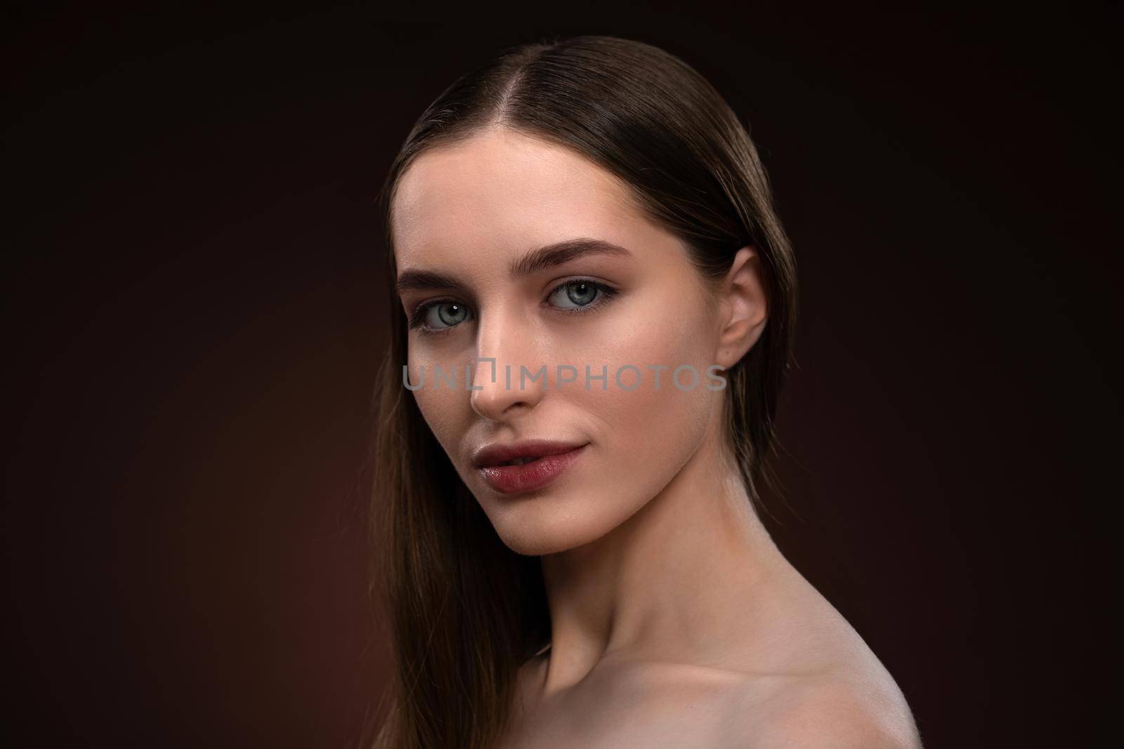 Beautiful woman face close up portrait with no make up. Healthy pure skin model isolated on black background. Natural make up concept. Spa and beautiful concept.